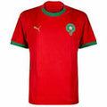 Red sports jersey with green accents and Puma logo on a white background