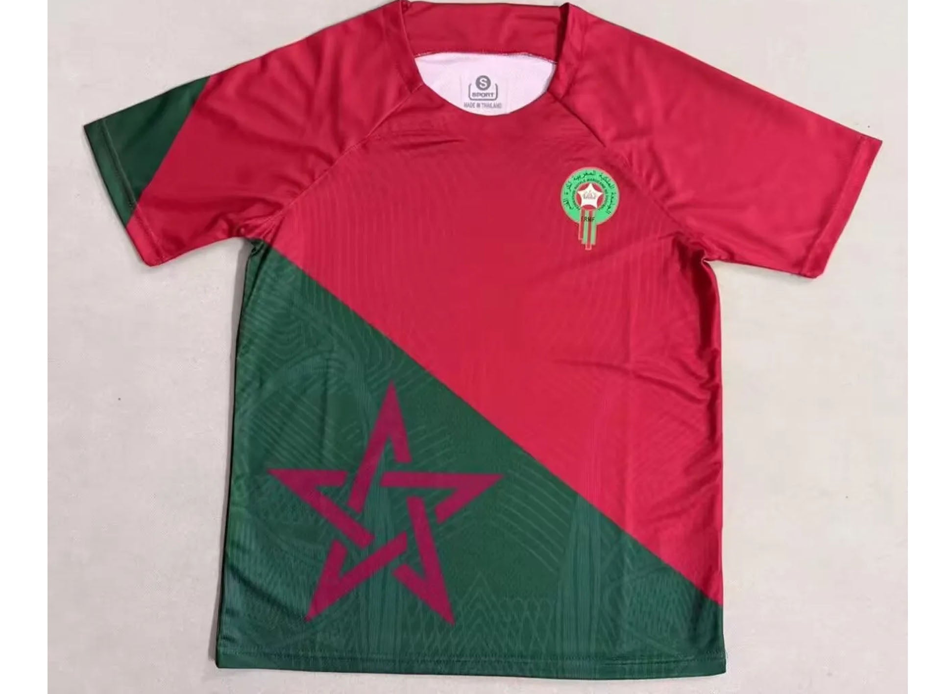 Red and green sports jersey with star design on a light gray background