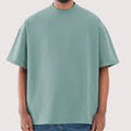 Person wearing a light green t-shirt on a plain background