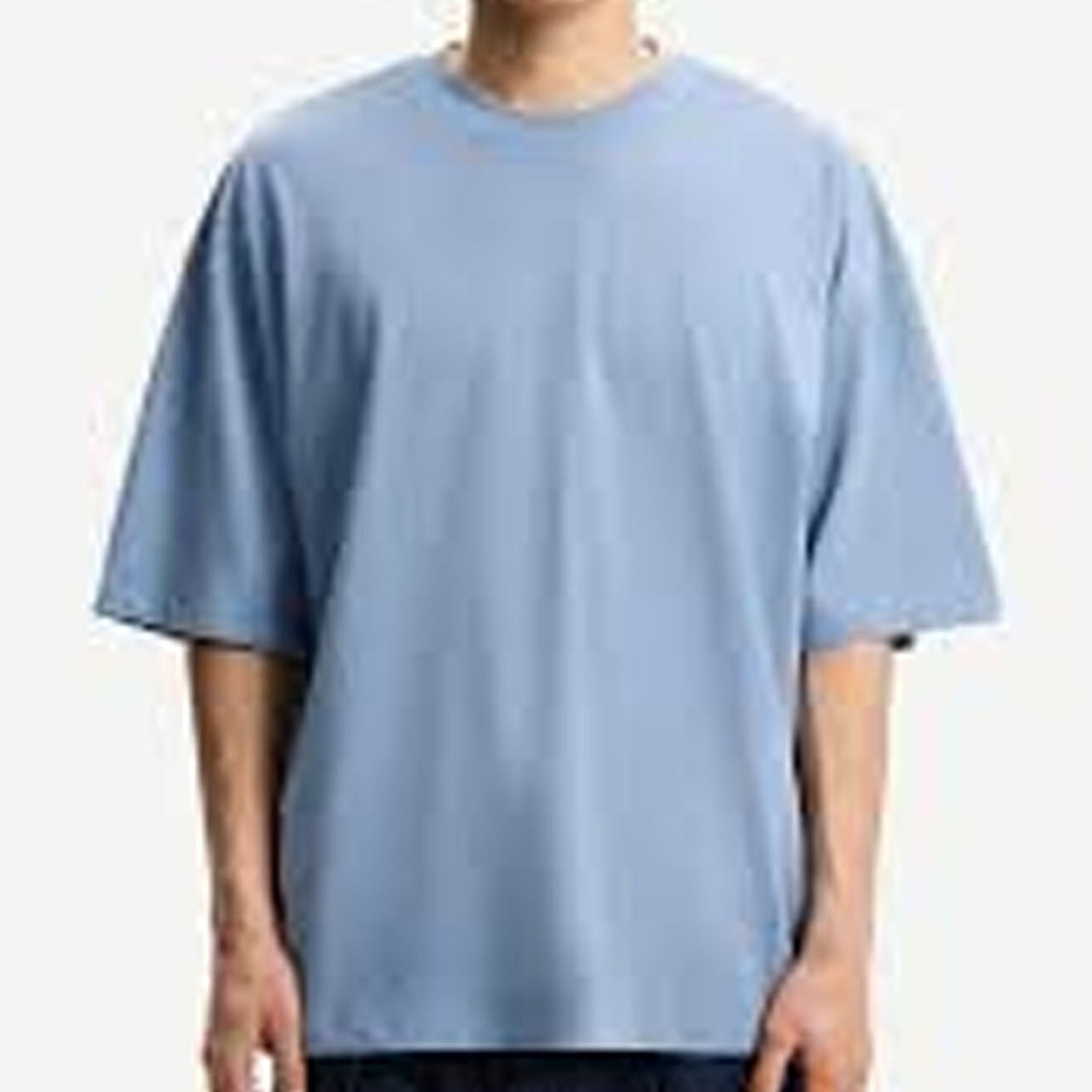 Person wearing a plain light blue t-shirt on a white background