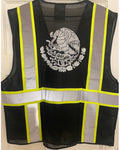 A black mesh safety vest with reflective silver stripes and bright yellow trim, featuring a white Mexican coat of arms printed on the back, shown against a white door background.