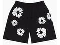 Black shorts with white floral ring patterns, featuring an elastic waistband and drawstring.
