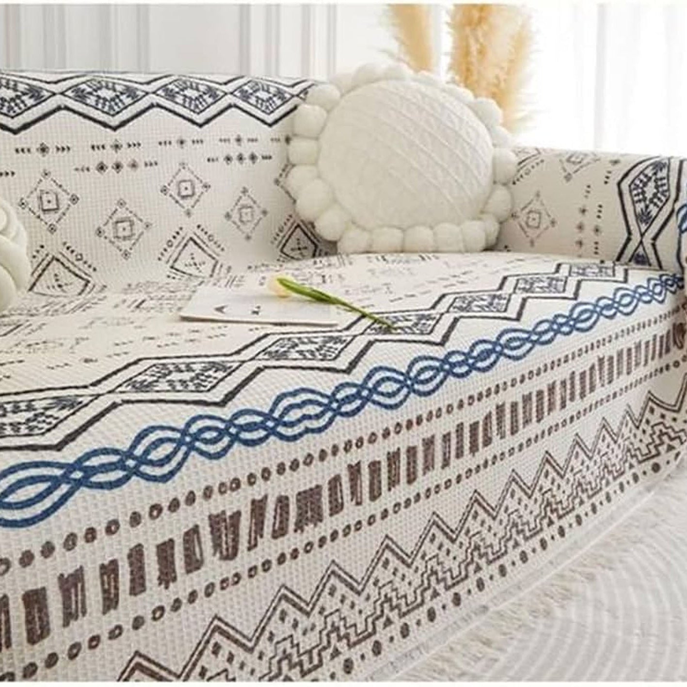 Patterned sofa cover on a sofa with decorative pillows.
