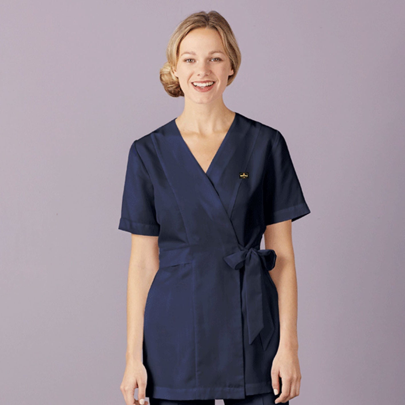 Woman wearing a navy blue uniform against a light purple background