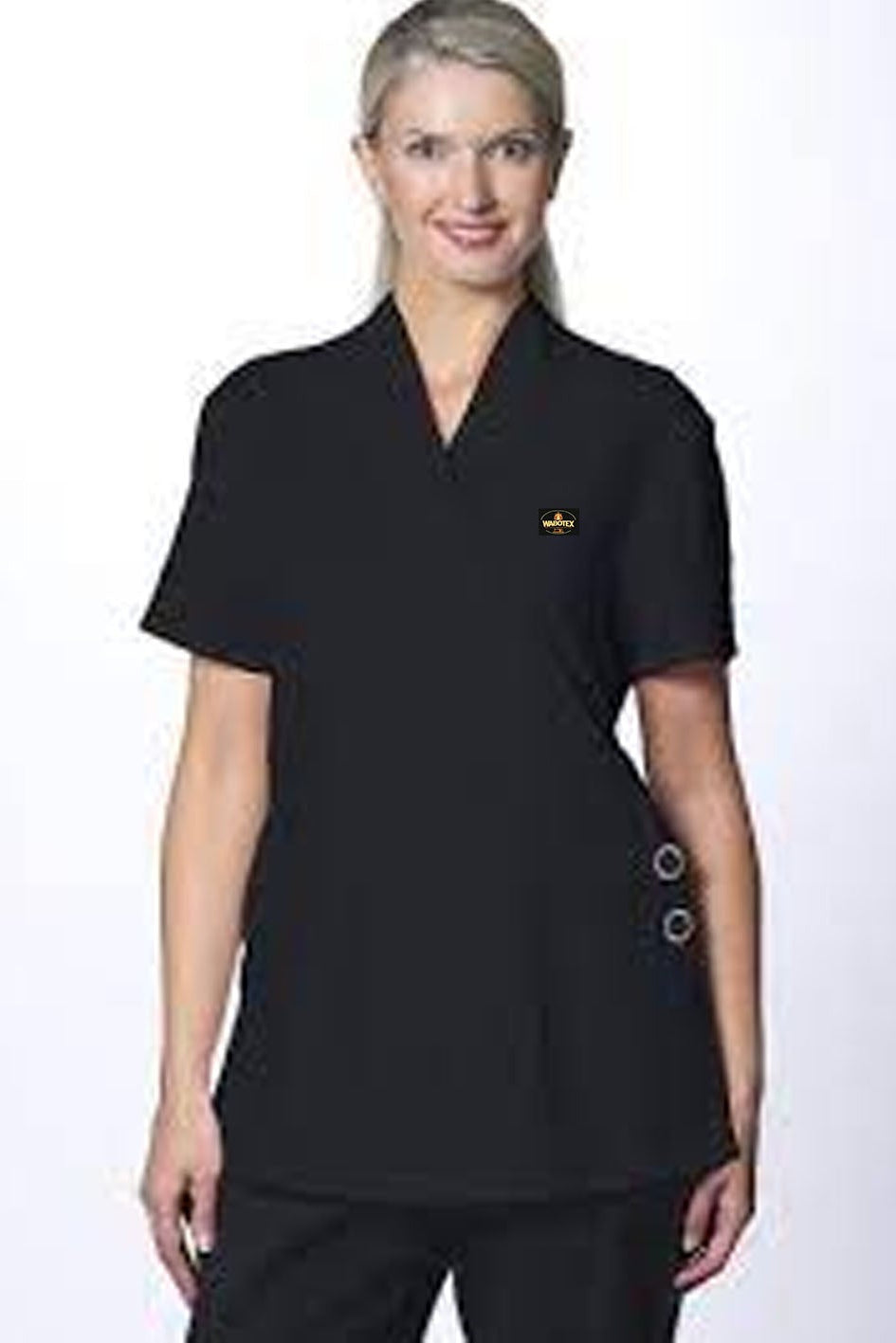 Woman wearing a black scrub top with a logo on a white background