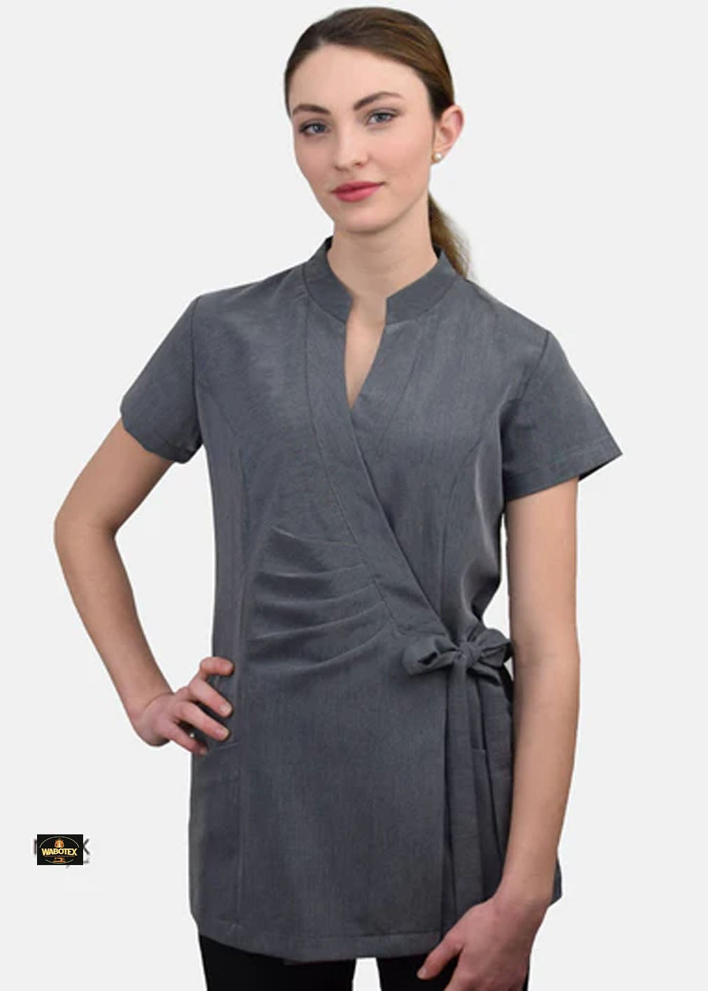 Woman wearing a gray wrap dress on a white background