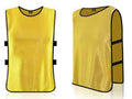 Two yellow bibs with black trim on a white background