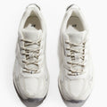 A pair of white and light gray chunky sneakers shown from a top-down view on a white background. The shoes feature a textured mesh and synthetic upper with matching laces, and the brand name 'H&M' is visible on the insole.