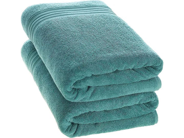 Two Torquoise Bath towels neatly folded