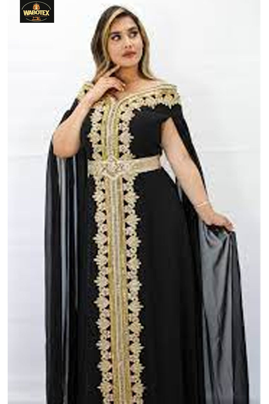 Woman wearing a black dress with gold embroidery on a white background