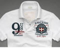 White Tshirt with embroidered logo and number 9 on a grey background