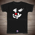 A black short-sleeve t-shirt with a graphic print of two white anime-style hands holding a red heart, displayed flat on a brown wood plank background.