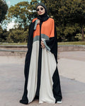 Woman wearing a colorful abaya in an outdoor setting