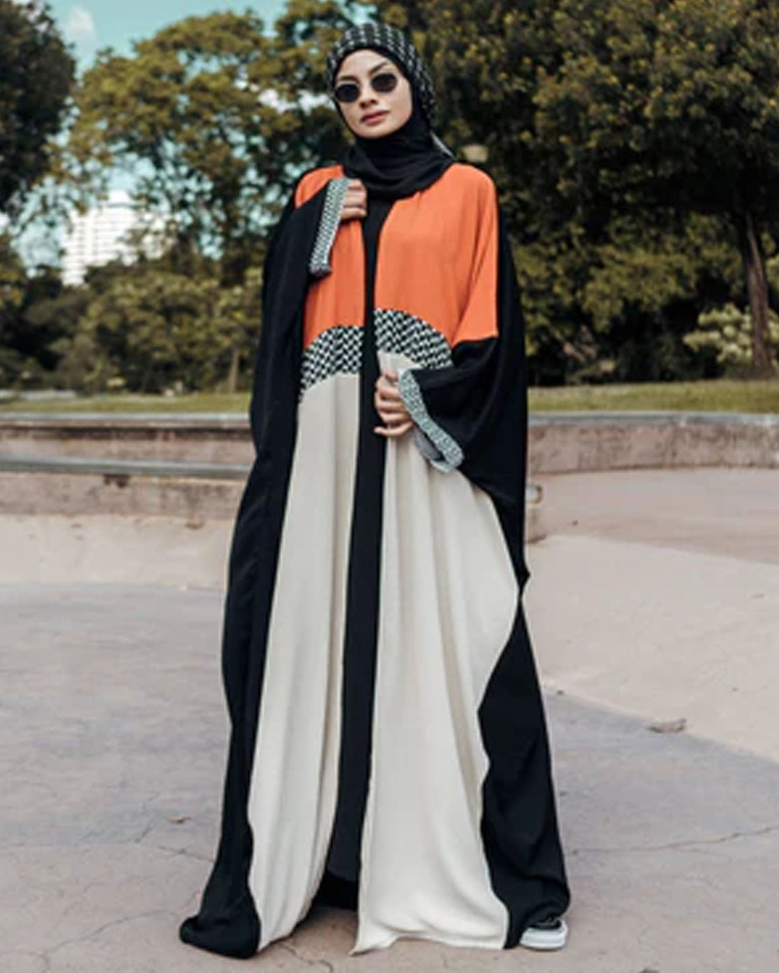 Woman wearing a colorful abaya in an outdoor setting