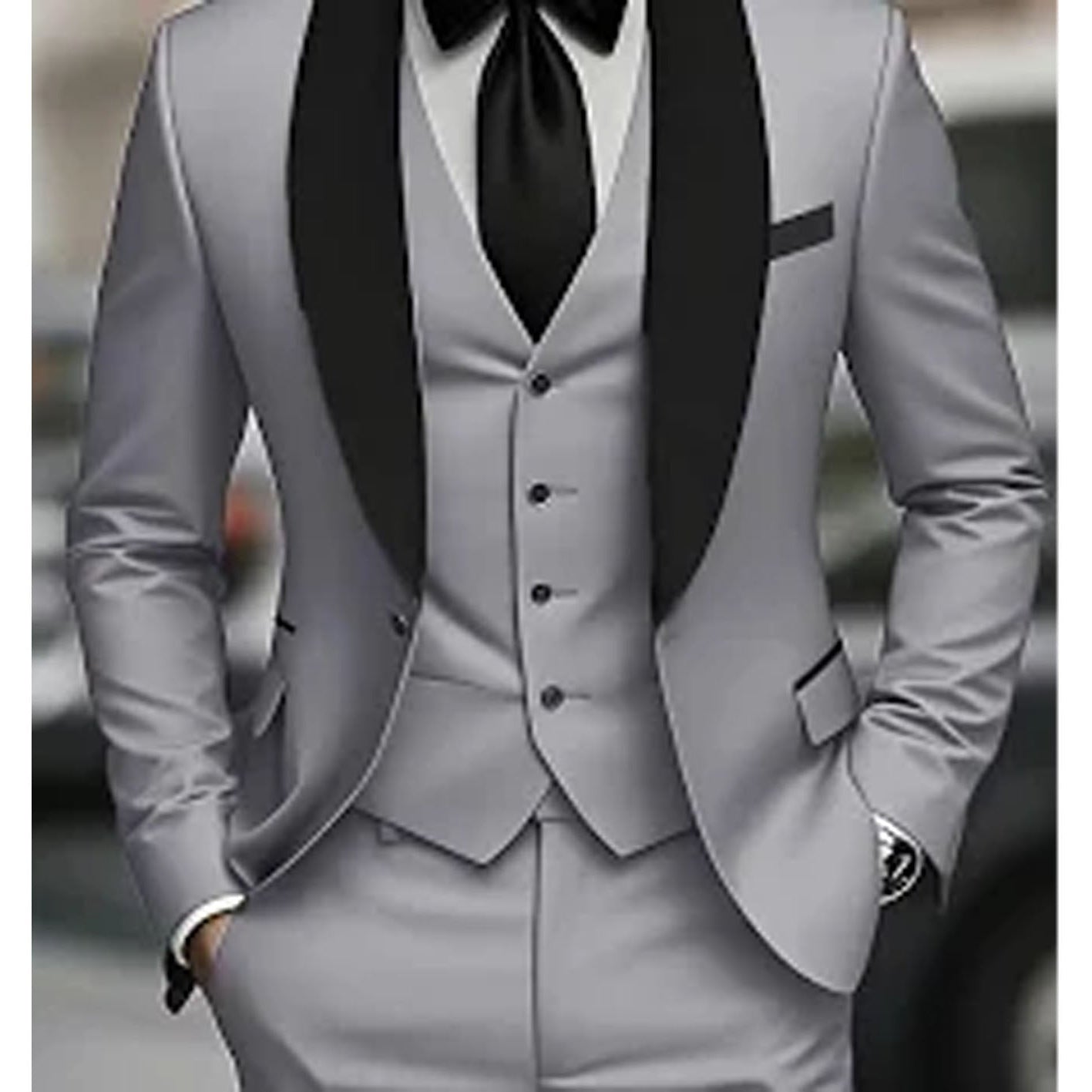 Gray suit with black lapels and bow tie on a blurred background