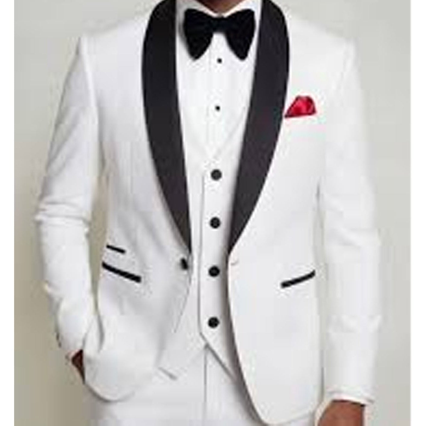 White tuxedo with black lapels and bow tie on a plain background