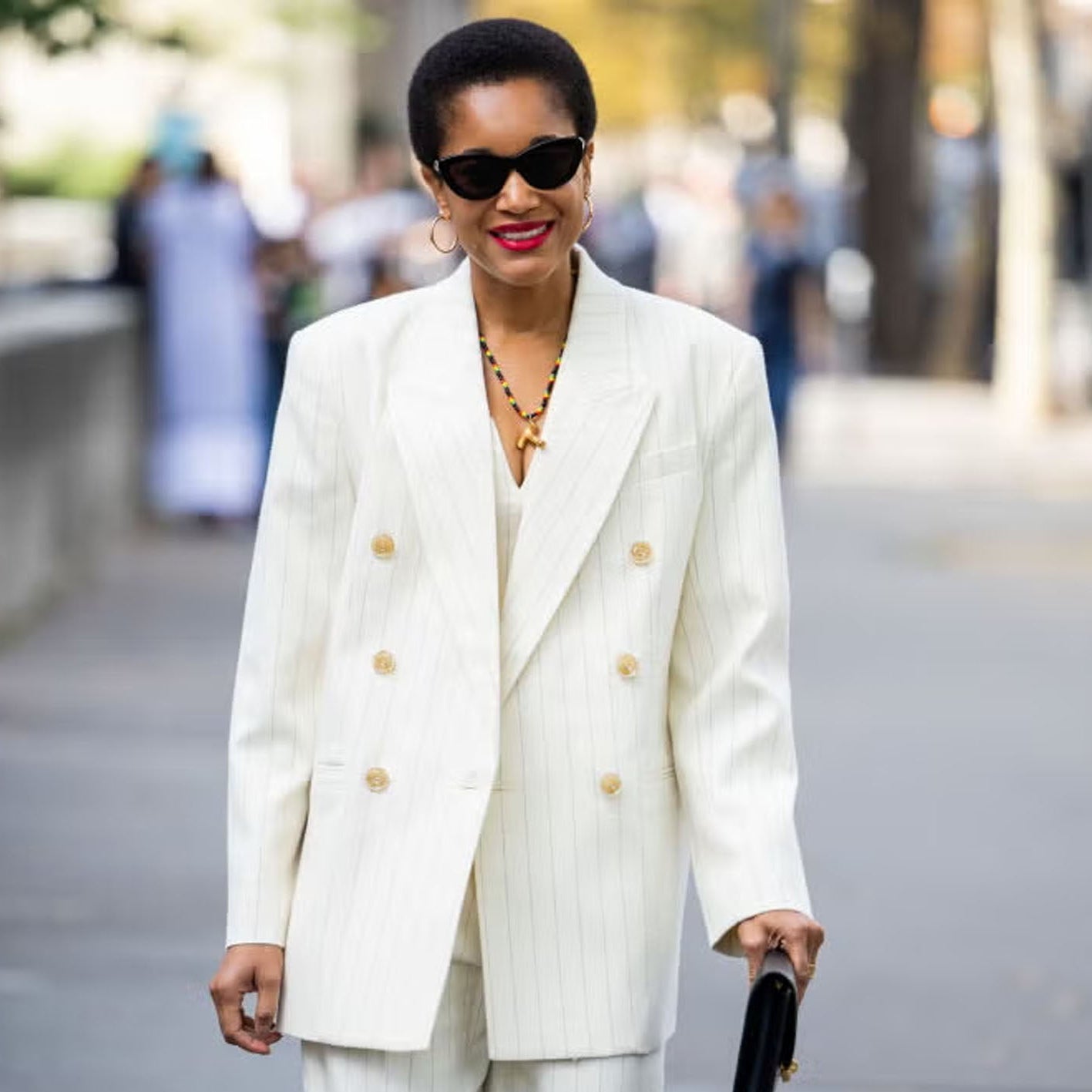 Woman Wearing white suit on a walkway