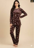 Woman wearing a floral pajama set on a beige background
