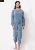 Woman wearing a blue pajama set on a white background