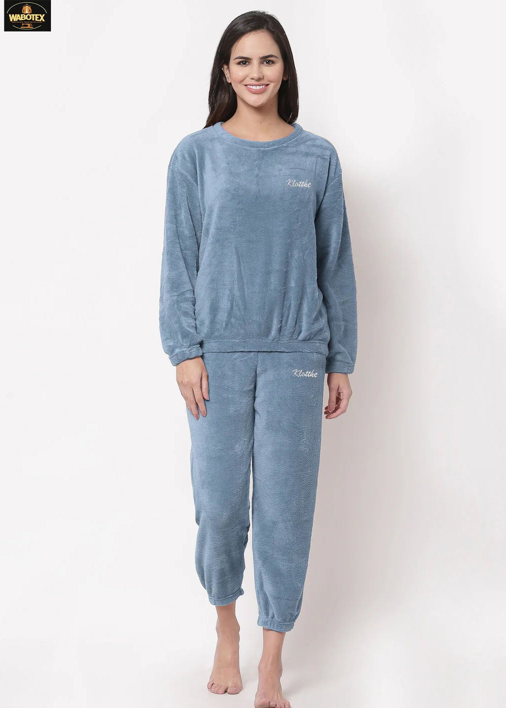 Woman wearing a blue pajama set on a white background