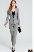 Woman wearing a gray suit with a black top and clutch on a white background