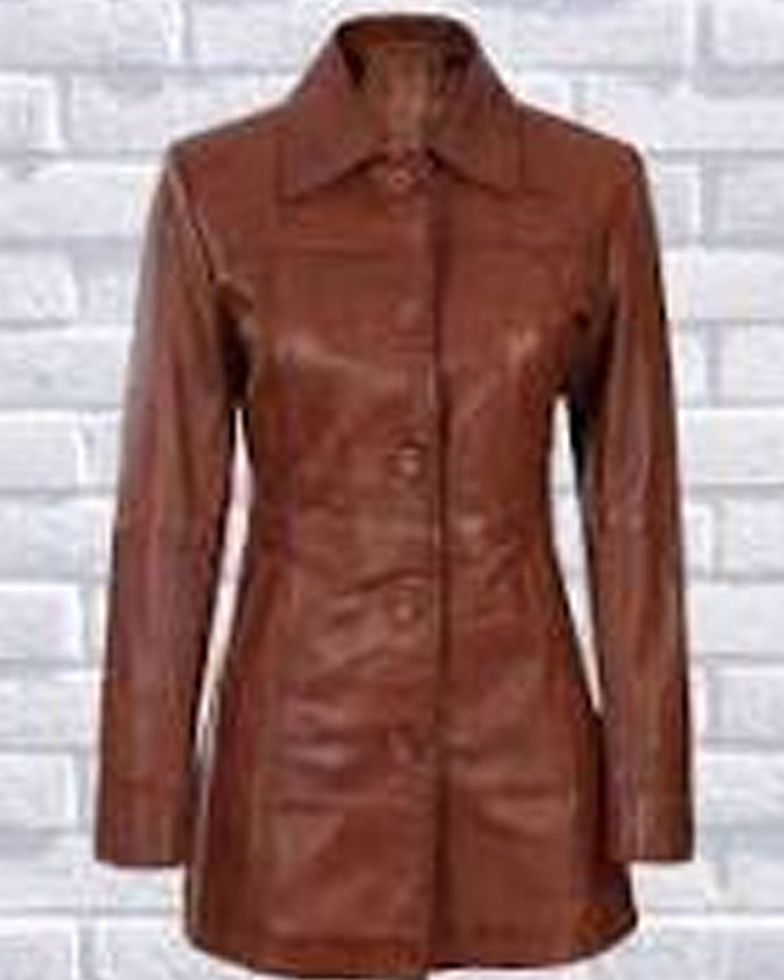 Brown leather coat on a white brick wall background