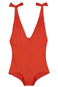 A bright red one-piece swimsuit with a deep V-neckline and tie-shoulder straps, shown flat against a solid white background.