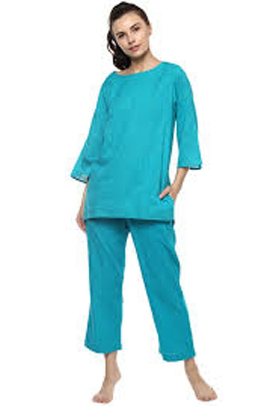 Woman wearing a teal pajama set on a white background
