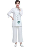 Woman wearing a white outfit with a floral design on a white background