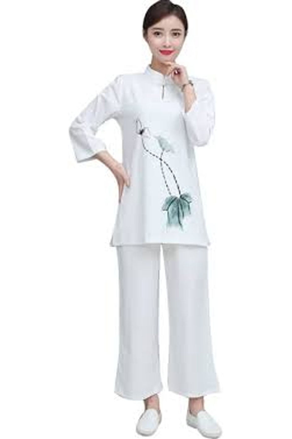 Woman wearing a white outfit with a floral design on a white background