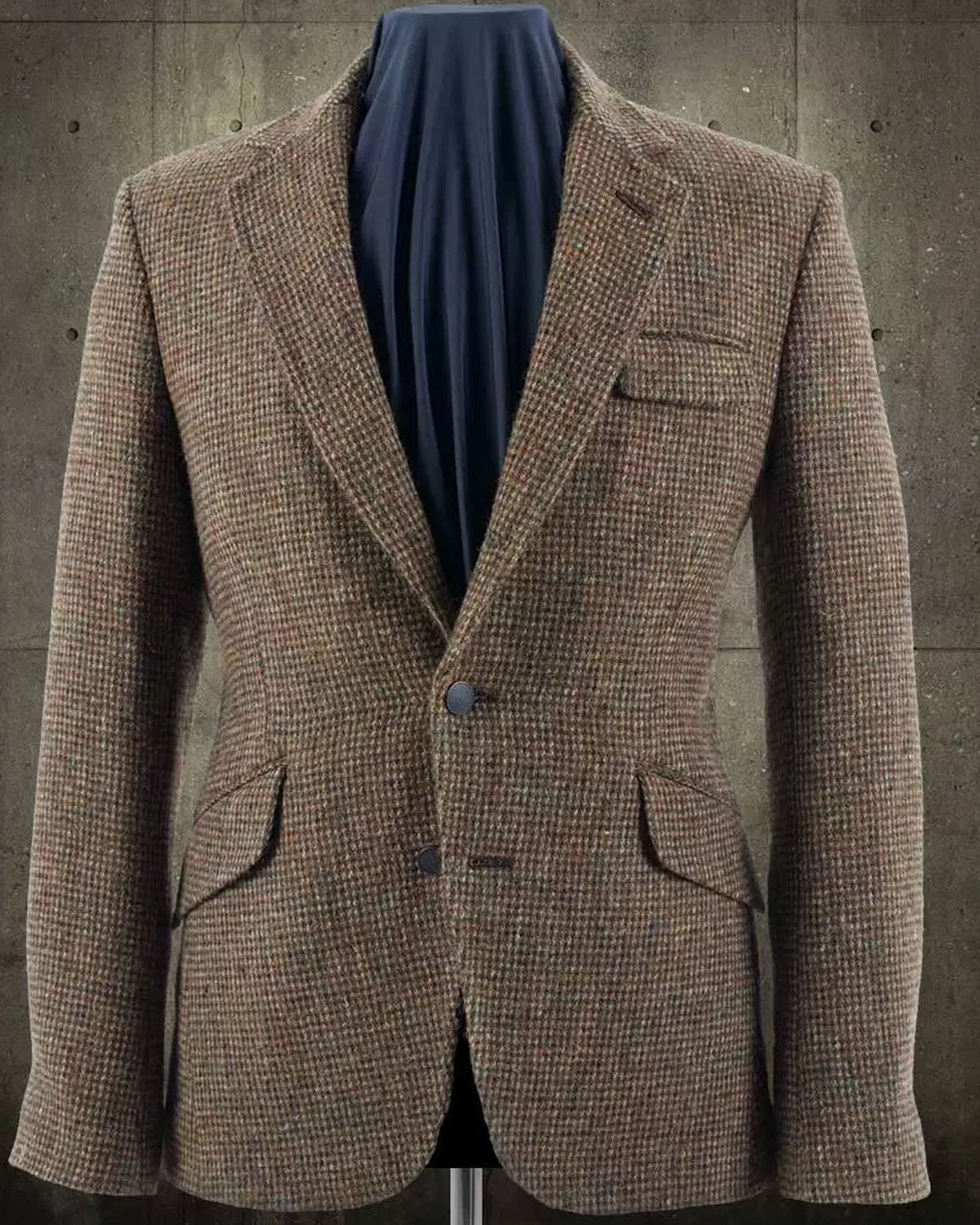 Brown checkered blazer on a mannequin against a textured wall background