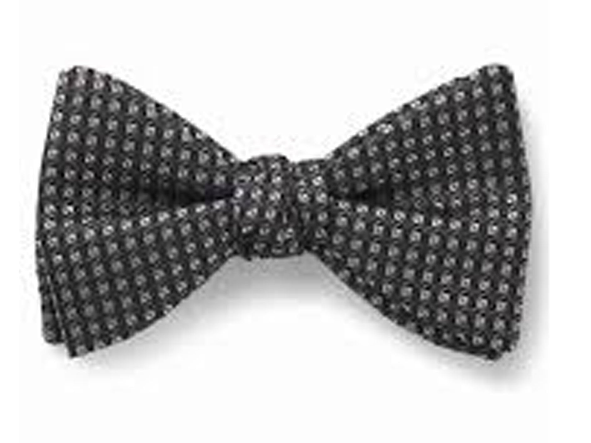 Black patterned bow tie on a white background