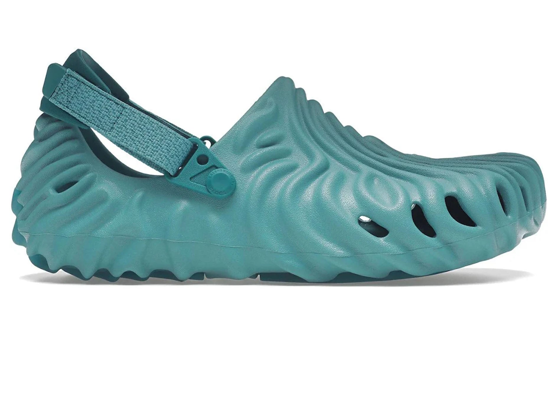 A single teal green waterproof clog shoe with a textured, wavy sole and an adjustable hook-and-loop strap, shown from a side profile on a white background.