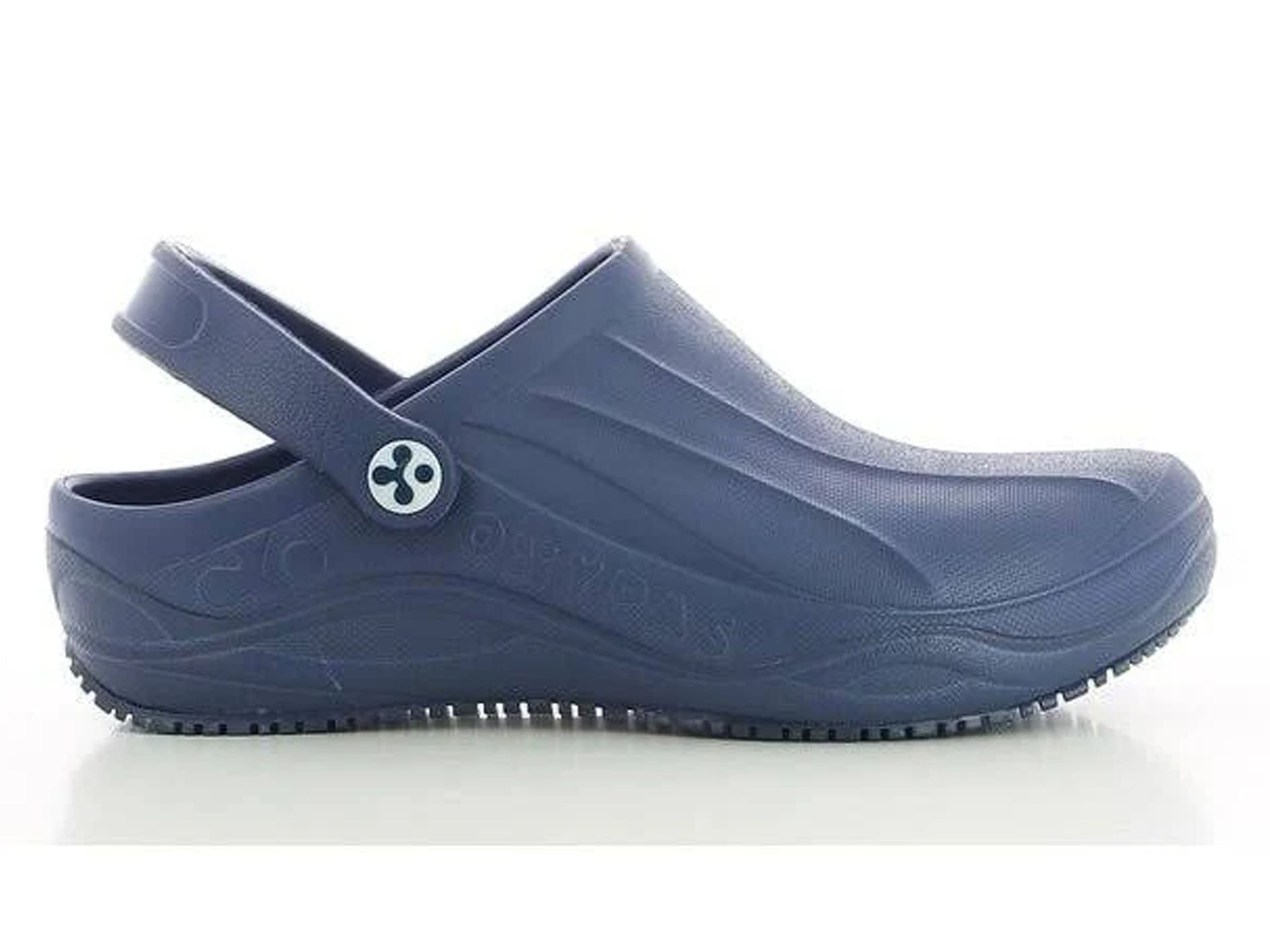 A single navy blue medical-style clog shoe with a strap and a small white button featuring a black cross, shown from the side on a white background.