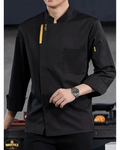 Black chef's jacket with yellow accents worn by a person, brand 'Wardtex' visible.