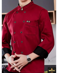 Red chef's coat with black buttons worn by a person, with Wabotex logo in the corner.