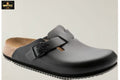 Gray clog shoe with a black strap on a light gray background