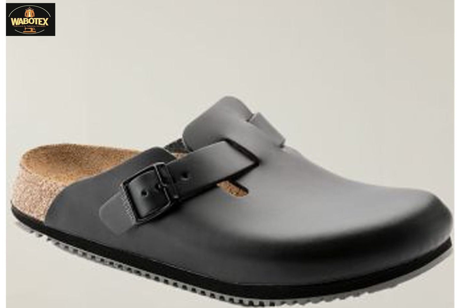 Gray clog shoe with a black strap on a light gray background