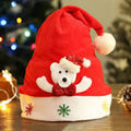 Red Santa hat with a white bear design on a wooden surface with Christmas decorations in the background.
