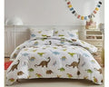 Dinosaur-themed bedding set on a bed in a child's bedroom.