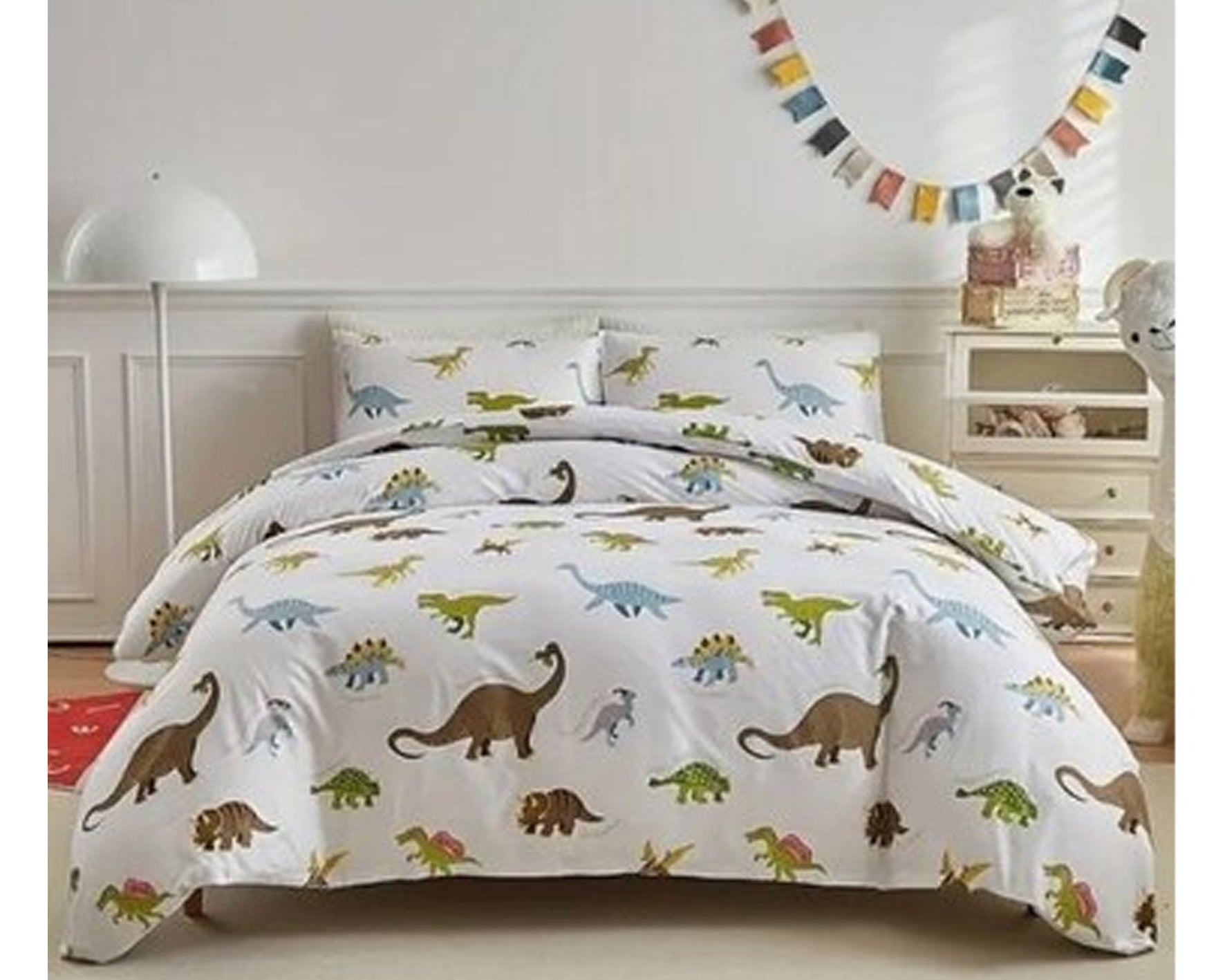 Dinosaur-themed bedding set on a bed in a child's bedroom.