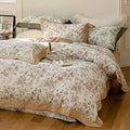 Floral patterned bedding set on a bed in a bedroom.