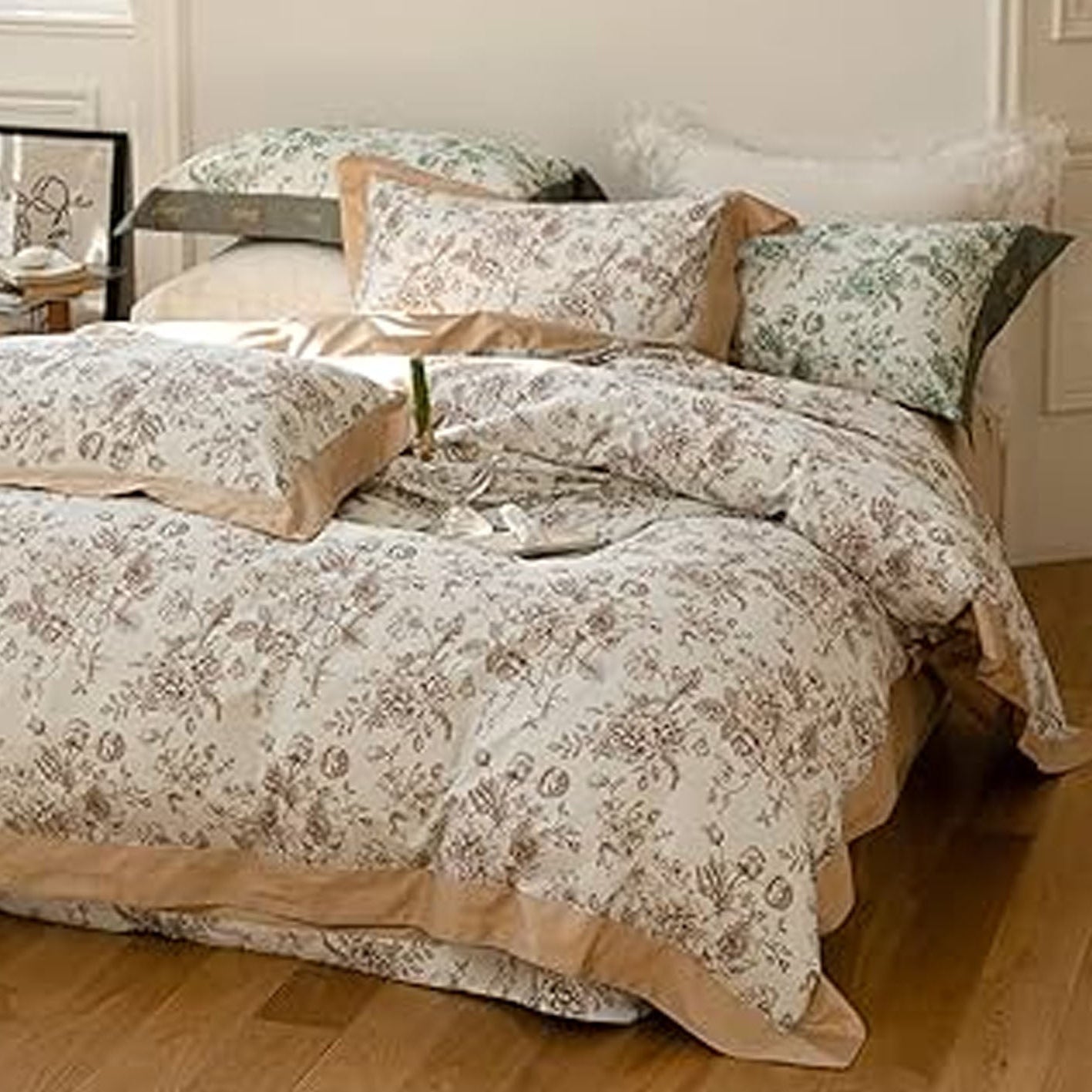 Floral patterned bedding set on a bed in a bedroom.