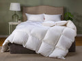 White comforter on a bed with pillows in a bedroom setting