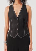 Black vest with white stitching worn by a person on a light gray background