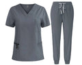 Gray scrub set with top and pants on a white background