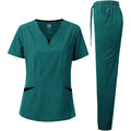 Teal scrub top and pants set on a white background