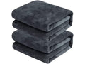 Stack of folded dark gray towels on a white background
