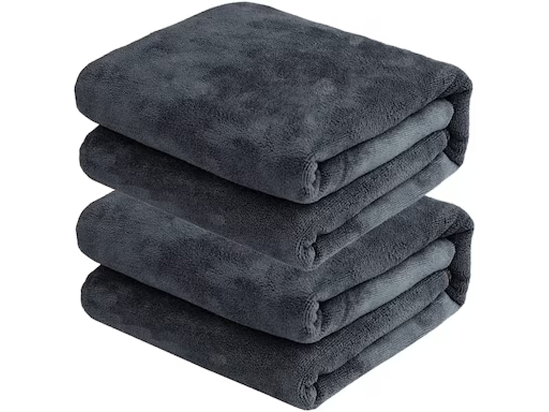 Stack of folded dark gray towels on a white background