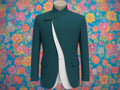 Teal blazer with white lining on a mannequin against a gray background